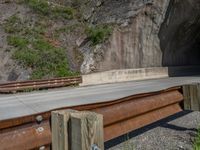 a road goes into a tunnel and through the hill to the other side of it