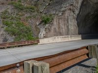 a road goes into a tunnel and through the hill to the other side of it