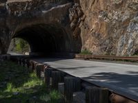 a road goes into a tunnel and through the hill to the other side of it