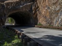 a road goes into a tunnel and through the hill to the other side of it