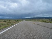 Colorado Road: Winding Through Nature under a Gloomy Grey Sky