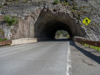 a road goes into a tunnel and through the hill to the other side of it