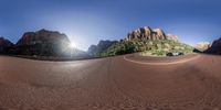 a desert that looks like it has sun shining over mountains in the background behind it