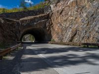 a road goes into a tunnel and through the hill to the other side of it