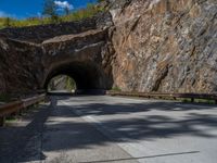 a road goes into a tunnel and through the hill to the other side of it