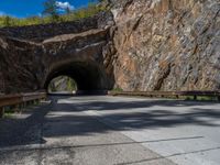 a road goes into a tunnel and through the hill to the other side of it