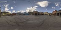 a fish eye lens is reflecting a street scene and buildings in the distance behind it