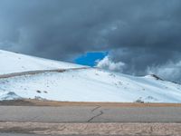 a person is on the top of a ramp on a steep hill by the ocean