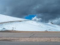 a person is on the top of a ramp on a steep hill by the ocean