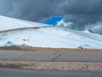 a person is on the top of a ramp on a steep hill by the ocean