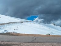 a person is on the top of a ramp on a steep hill by the ocean