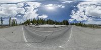 this is an image of the panorama mirror reflection in this picture shows the road through the trees