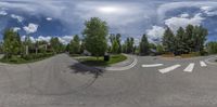 360 - ray image showing empty intersection for cars and pedestrians to pass by in residential area