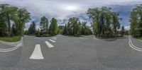 a panoramic image shows an intersection with multiple street lines, with the view of houses in the distance