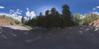 the 360 - camera image shows the dirt road that goes along the hill to the river