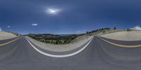 a curved roadway that looks like it has been turned upside down to see the sun in the sky