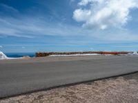 a person is on the top of a ramp on a steep hill by the ocean