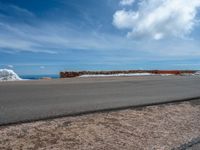 a person is on the top of a ramp on a steep hill by the ocean