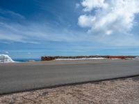 a person is on the top of a ramp on a steep hill by the ocean