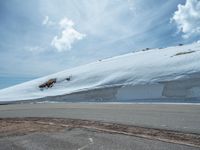 the man is at the top of a mountain on skis with mountains in the background