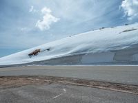 the man is at the top of a mountain on skis with mountains in the background