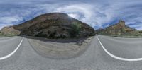 a 3d image of a mountain peak and a road with curves of white lines in the middle