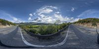 a view from a car looking up at a highway with a road marker and a cloudy sky