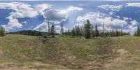 the image depicts an empty clearing of land in the woods next to the forest path