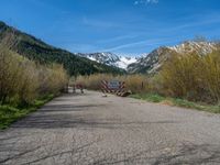 an open gate sits behind a warning sign on the side of the road that's blocked off