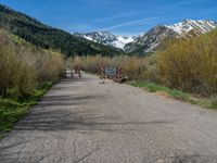 an open gate sits behind a warning sign on the side of the road that's blocked off