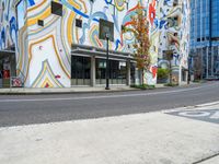 the multi - color painted building has a red fire hydrant in front of it