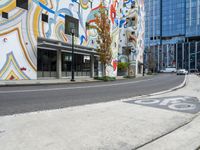 the multi - color painted building has a red fire hydrant in front of it