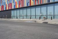 a picture of the street outside a multi - color building with markings on it's parking spaces