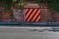 the door to an old building is red and yellow with a striped stripe pattern on it