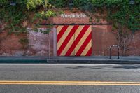 the door to an old building is red and yellow with a striped stripe pattern on it