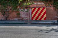 the door to an old building is red and yellow with a striped stripe pattern on it