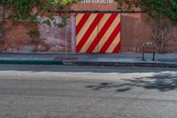 the door to an old building is red and yellow with a striped stripe pattern on it