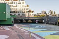 a large area covered in colorful, dotted paint on the sidewalk in front of some buildings