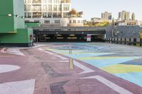 a large area covered in colorful, dotted paint on the sidewalk in front of some buildings