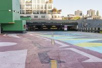 a large area covered in colorful, dotted paint on the sidewalk in front of some buildings