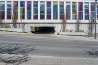 a large white building with colorful glass windows and a gate on the side of it