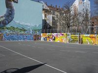 a man riding a bicycle past a mural of an elephant on the side of a building