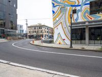 a street corner with a colorful art piece and a traffic light on top of it