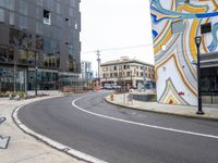 a street corner with a colorful art piece and a traffic light on top of it