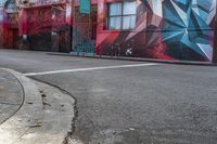 a colorful mural is on the side of an alleyway near a red fire hydrant