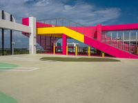 colorful staircases are next to a building with stairs on the other side of it