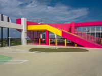 colorful staircases are next to a building with stairs on the other side of it