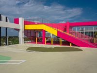 colorful staircases are next to a building with stairs on the other side of it