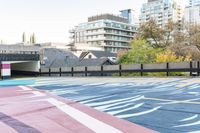 colorful parking space in front of tall buildings and apartment complex in urban area area with skateboarder