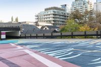 colorful parking space in front of tall buildings and apartment complex in urban area area with skateboarder